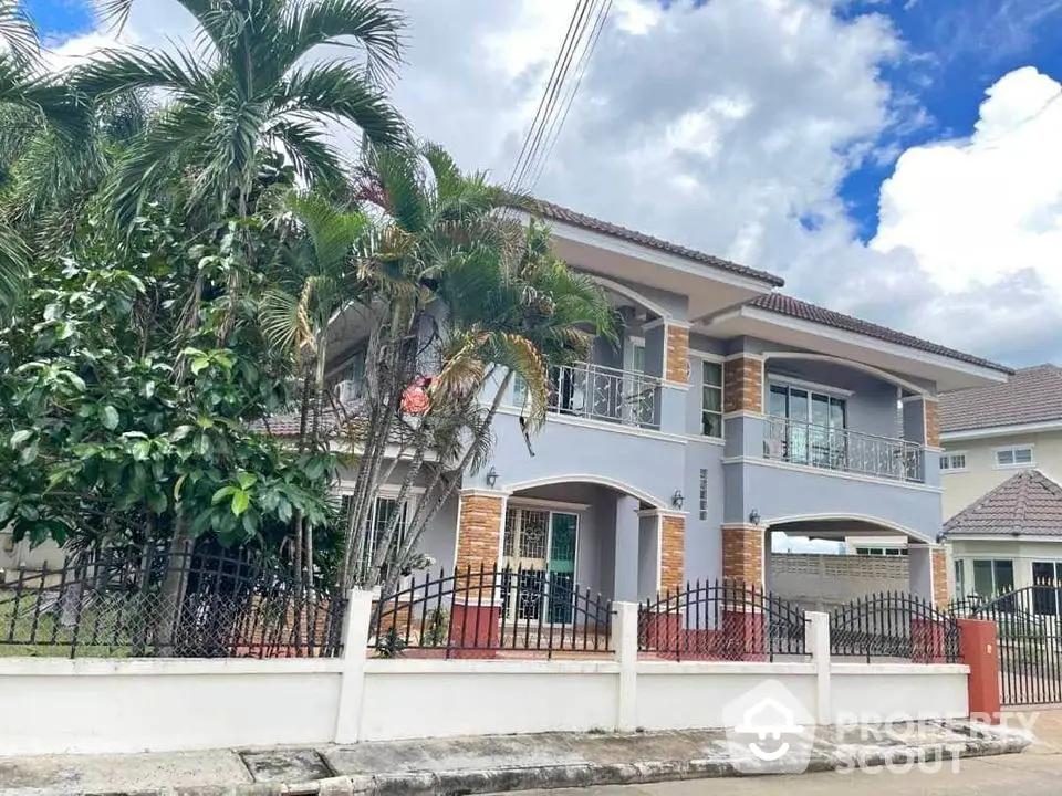 Stunning two-story house with lush garden and modern architecture in a serene neighborhood.