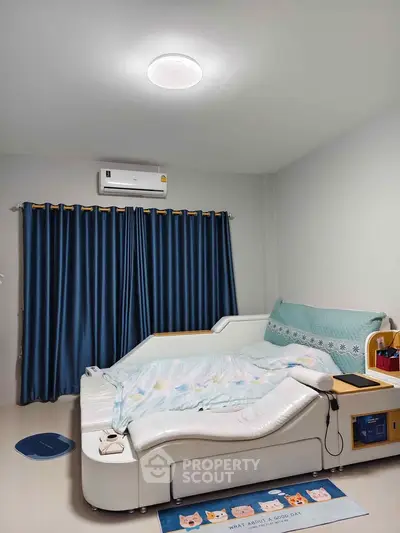 Cozy bedroom with modern bed and air conditioning, featuring elegant blue curtains and stylish decor.