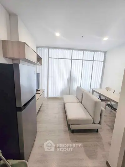 Modern living room with sleek furniture and natural light, perfect for urban living.