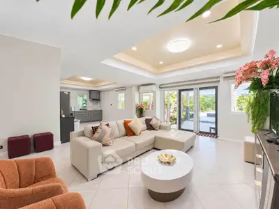 Spacious and elegant living room with modern decor and pool view, perfect for luxury living.