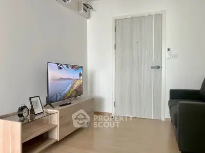 Modern living room with sleek wooden flooring and stylish TV setup