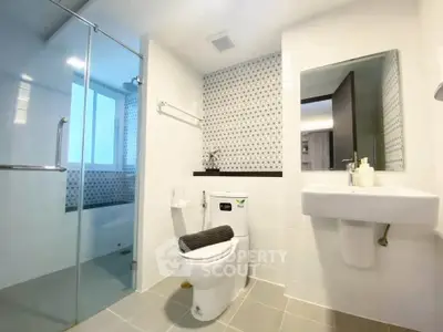 Modern bathroom with glass shower and sleek fixtures