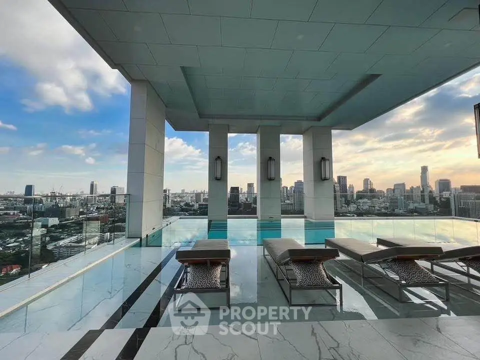 Luxurious rooftop pool with stunning city skyline views and elegant lounge chairs.