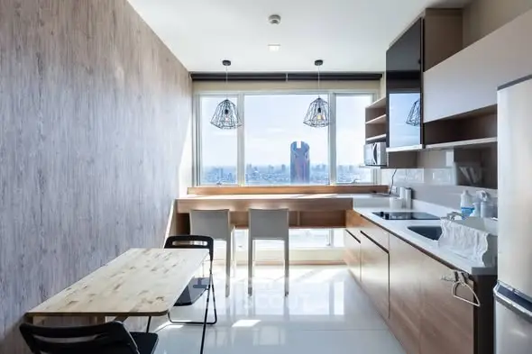 Modern kitchen with panoramic city view and sleek wooden cabinetry