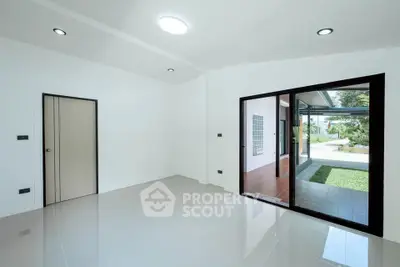 Spacious modern interior with sliding glass doors and garden view