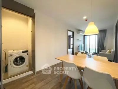Modern apartment interior with dining area and washing machine closet