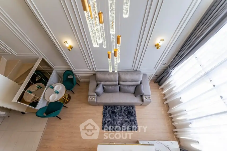 Luxurious modern living room with high ceiling and elegant chandelier