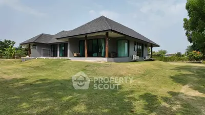 Modern single-story house with spacious lawn and sleek design