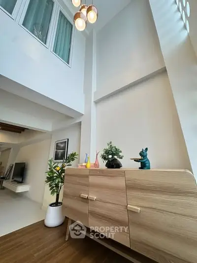 Modern living room with high ceiling and stylish decor