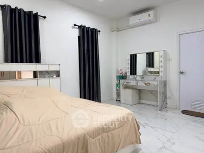 Spacious bedroom with modern decor and air conditioning, featuring a stylish vanity and elegant marble flooring.