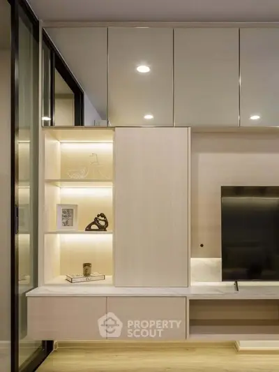 Modern living room with sleek built-in storage and TV unit, featuring ambient lighting and minimalist decor.