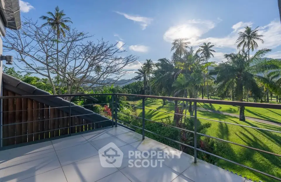 Stunning balcony view overlooking lush green golf course and palm trees under a bright blue sky.