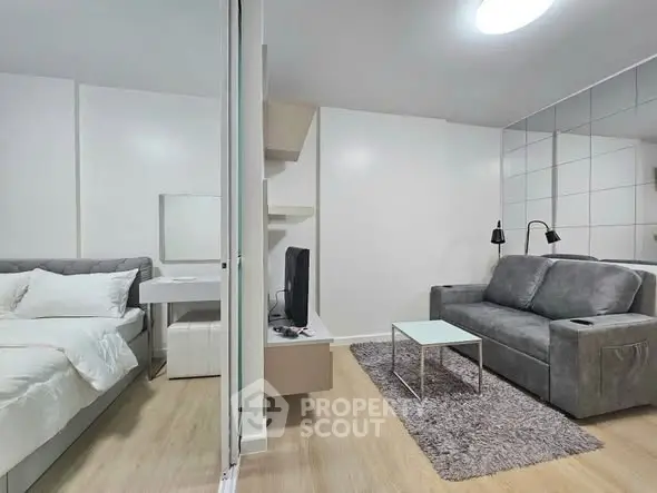 Modern studio apartment with cozy living area and stylish bedroom