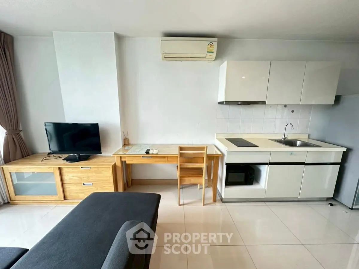 Modern studio apartment with compact kitchen and cozy living area