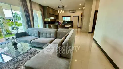 Spacious modern living room with open kitchen and garden view