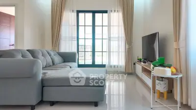 Modern living room with large window and stylish furniture