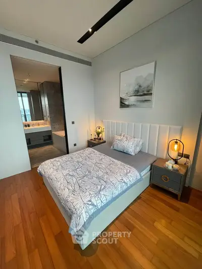 Modern bedroom with elegant decor and ensuite bathroom in luxury apartment