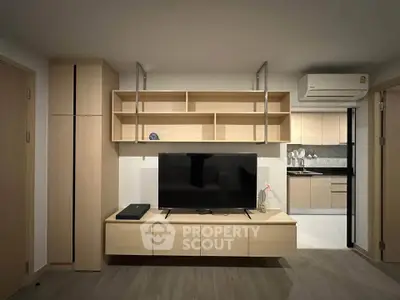 Modern living room with sleek wooden furniture and open kitchen layout
