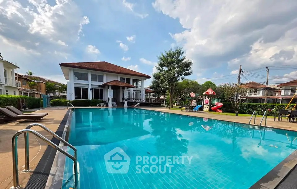 Luxurious residential community with a pristine swimming pool and modern clubhouse under a clear blue sky.