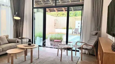 Chic living room with modern furniture and pool view, perfect for relaxation and entertaining.
