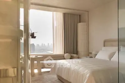 Luxurious bedroom with panoramic city view and elegant furnishings.