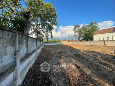 Spacious vacant land with clear blue sky, ideal for development opportunities.