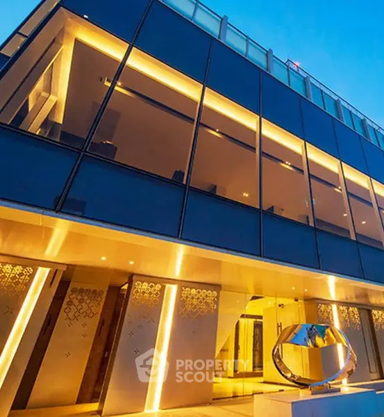 Modern luxury building exterior with sleek glass facade and ambient lighting