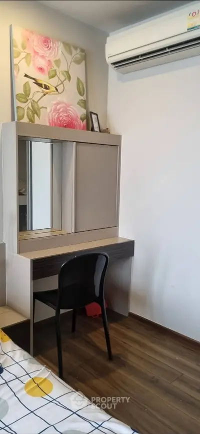 Cozy bedroom with modern vanity and air conditioning, perfect for relaxation and comfort.