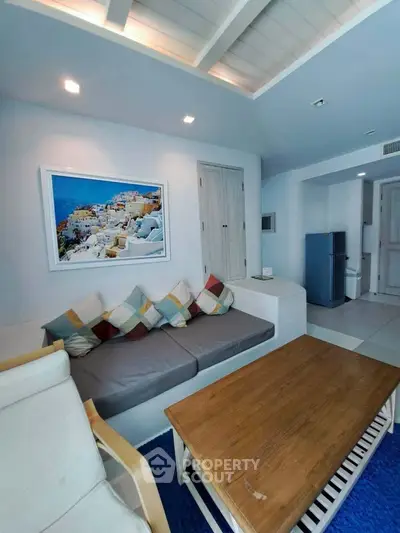 Charming living room with cozy seating and vibrant wall art, perfect for relaxation and entertaining.
