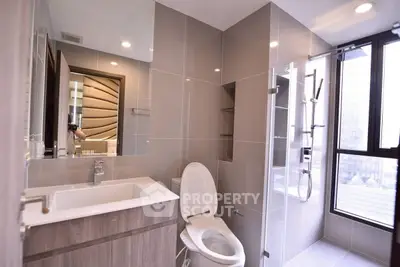 Modern bathroom with sleek fixtures and large window for natural light.