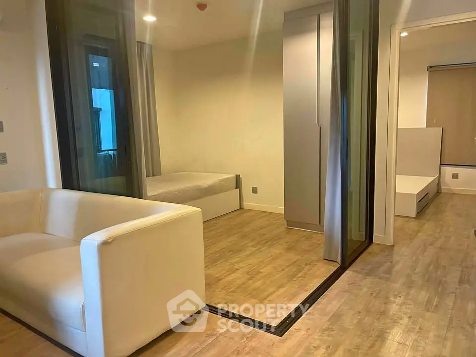 Modern studio apartment with wooden flooring and sleek furniture design