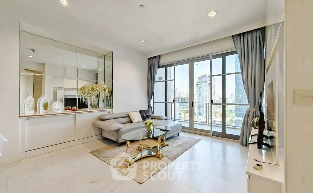 Luxurious living room with city view, elegant decor, and floor-to-ceiling windows in a modern apartment.