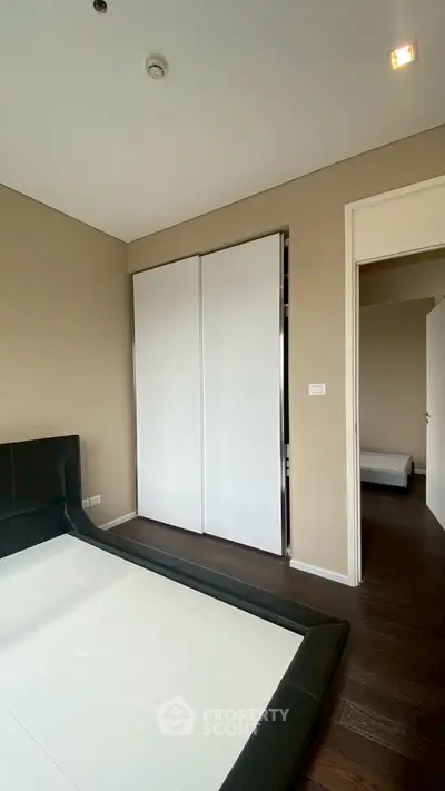 Modern bedroom with sleek design and sliding closet doors.