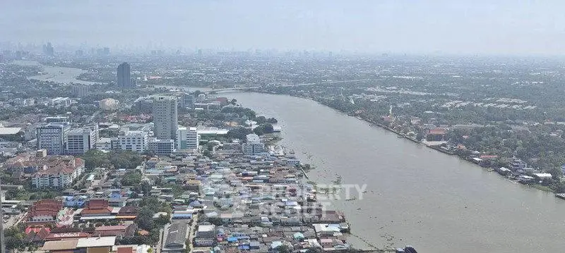 Stunning aerial view of a riverfront cityscape with sprawling urban and natural landscapes.