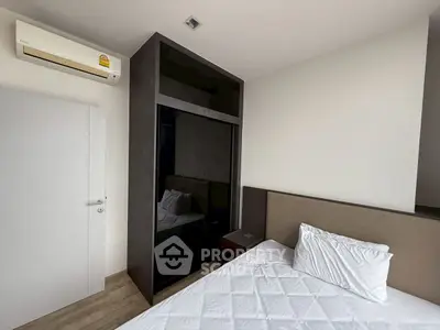 Modern bedroom with sleek wardrobe and air conditioning unit
