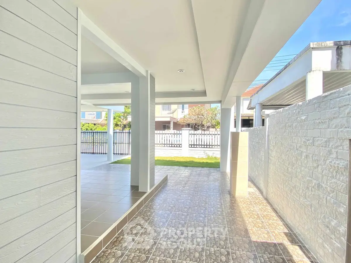 Spacious covered outdoor area with tiled flooring and modern design.