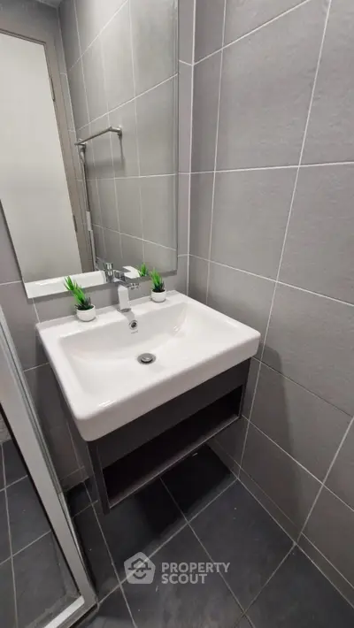 Modern bathroom with sleek sink and stylish gray tiles