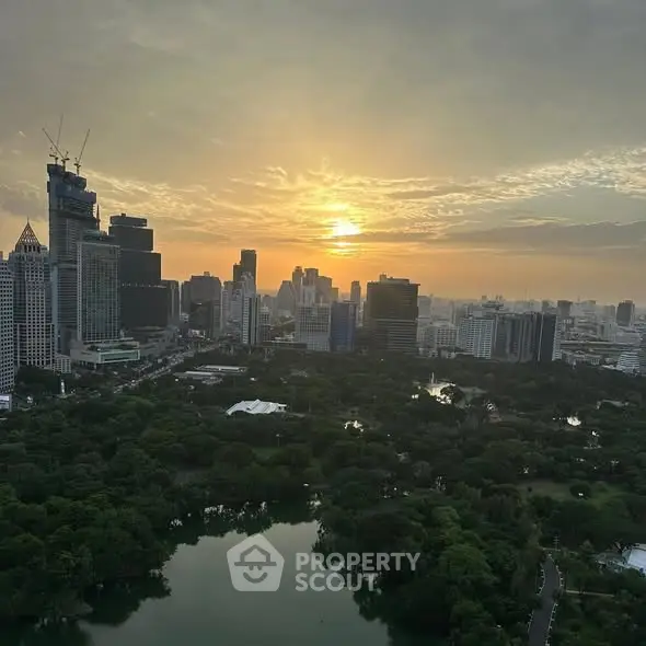 Stunning cityscape view with lush park and skyline at sunset.