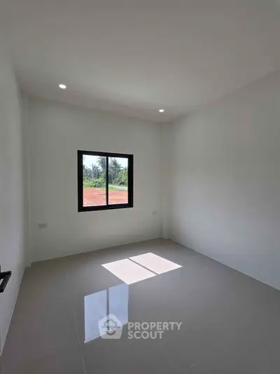 Bright empty room with large window and glossy tiled floor, perfect for customization.