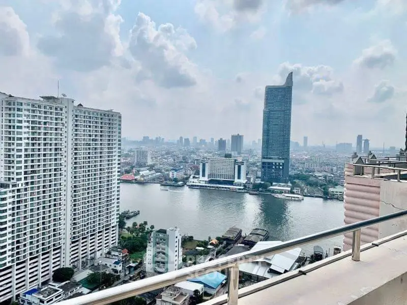 Stunning cityscape view from high-rise balcony overlooking river and skyline.