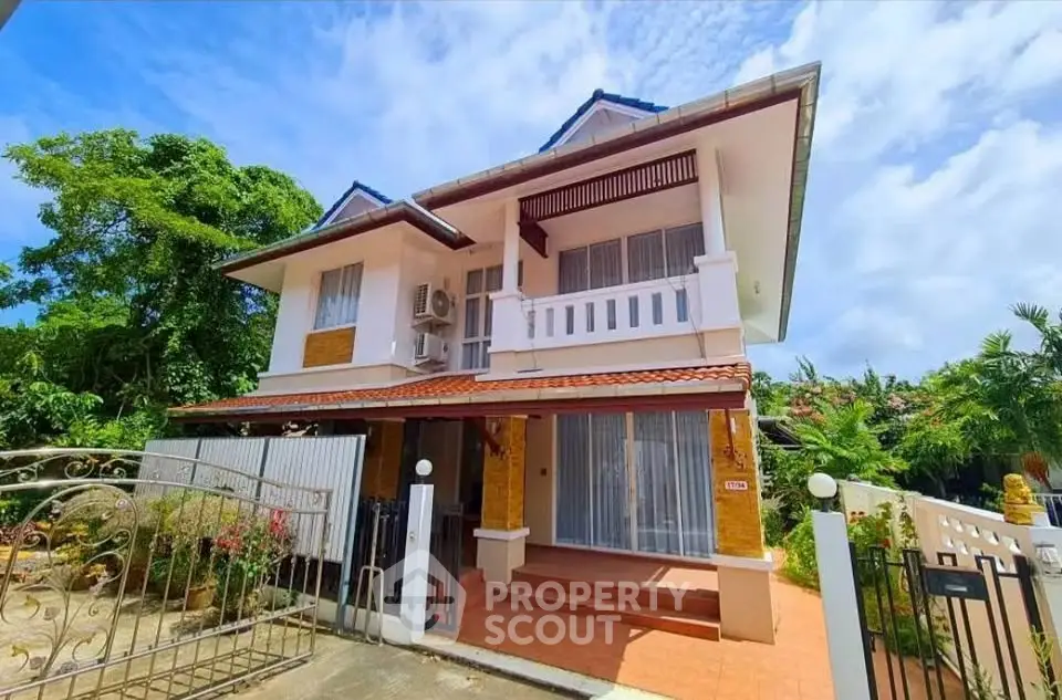Charming two-story house with lush garden and spacious balcony, perfect for family living.