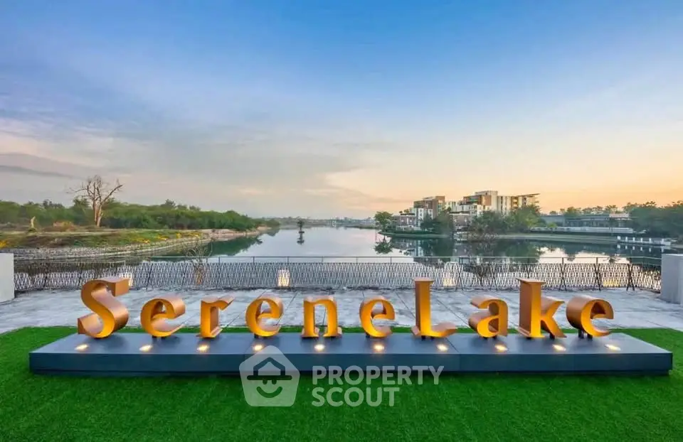 Stunning lakeside view with modern architecture at Serene Lake property.