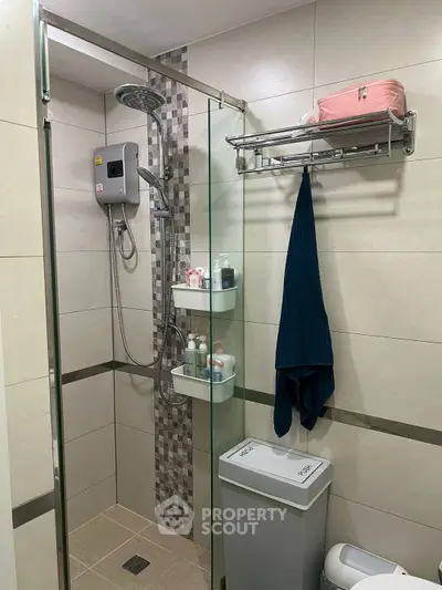 Modern bathroom with glass shower enclosure and wall-mounted storage
