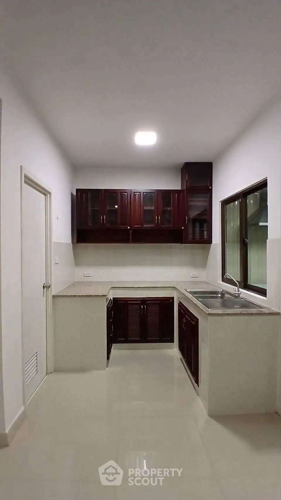 Modern kitchen with sleek cabinetry and spacious countertops in a contemporary home.