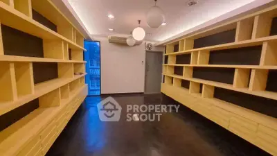 Spacious modern study room with built-in wooden shelves and elegant lighting