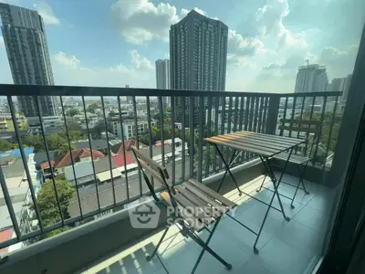 Modern balcony with city view and outdoor seating in high-rise apartment