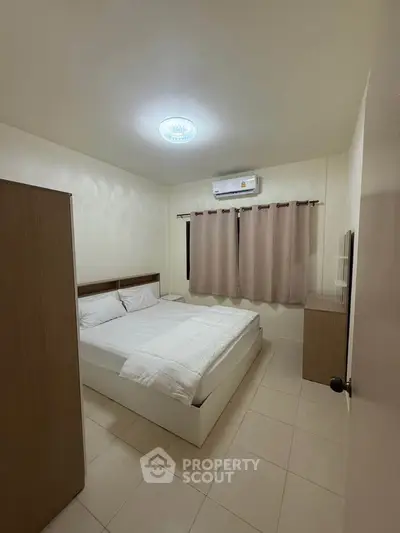 Cozy bedroom with modern furnishings and air conditioning