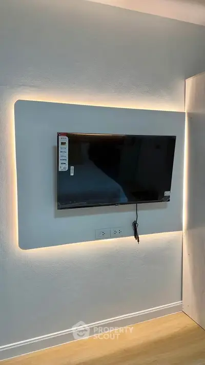 Modern living room with wall-mounted TV and ambient lighting