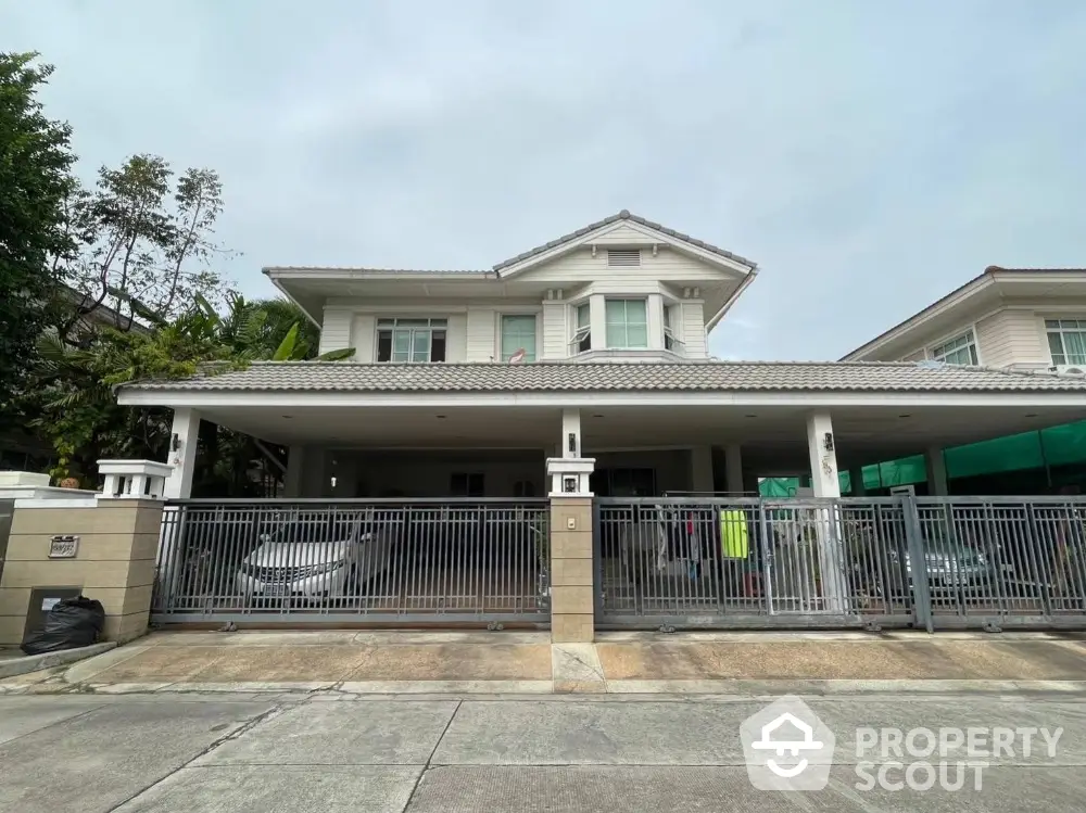 Spacious two-story house with gated driveway and modern design