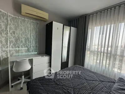 Modern bedroom with large window, stylish furniture, and air conditioning unit.